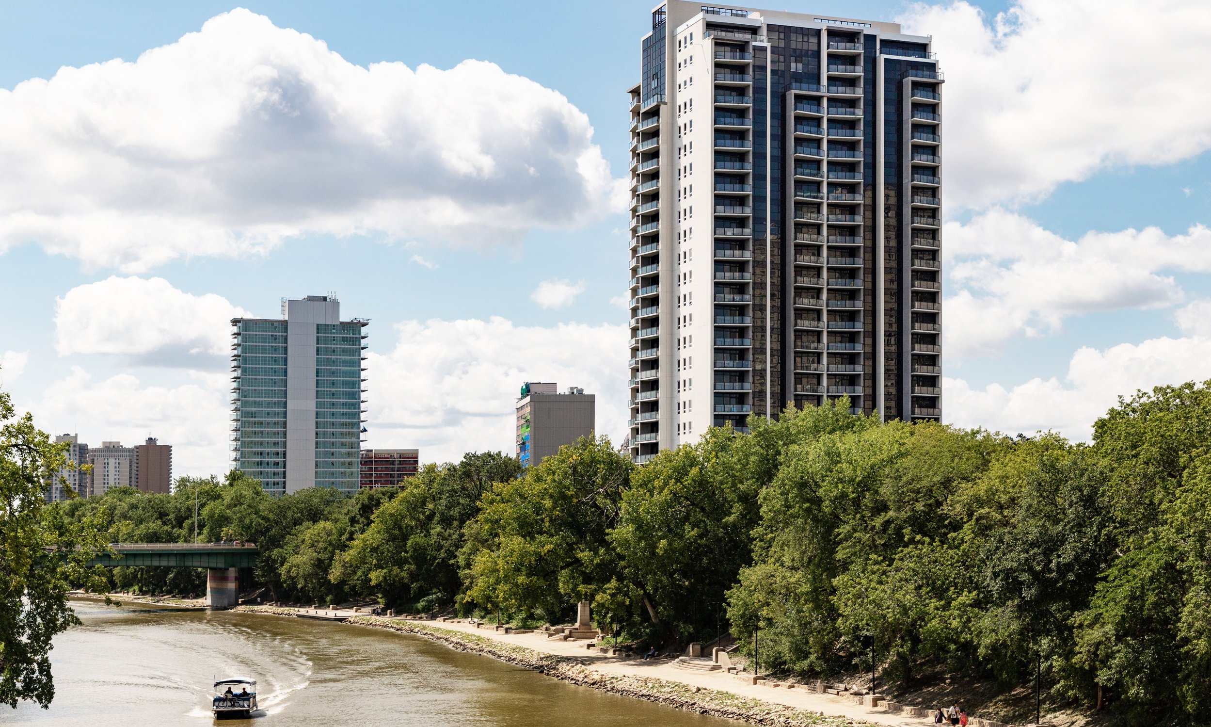 High-rise featuring a speedboat on the river